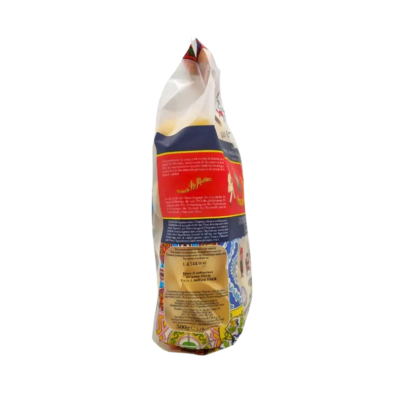 Côté du paquet de Conchiglioni Rigati 500g avec informations sur la provenance des ingrédients, orné de motifs décoratifs colorés