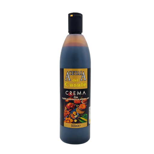 Face avant de la bouteille de crème au vinaigre balsamique de Modène I.G.P. Acetaia del Casale 500ml, étiquette noire et dorée illustrée de fruits, légumes et mets gourmands.