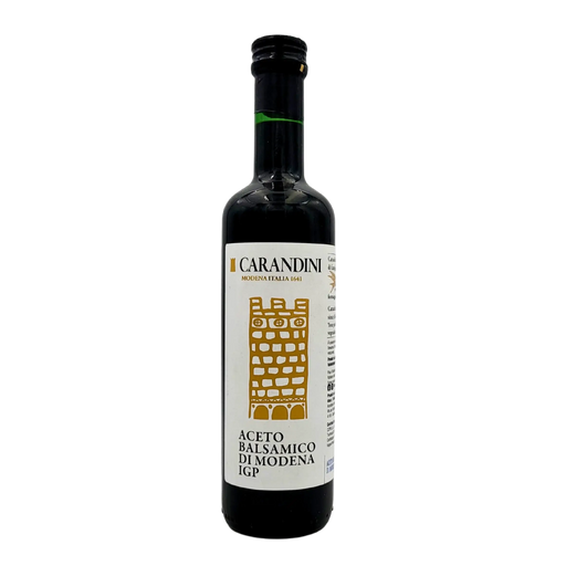 Face avant de la bouteille de vinaigre balsamique de Modène I.G.P. Carandini 500ml, avec étiquette blanche et dorée représentant une tour stylisée.